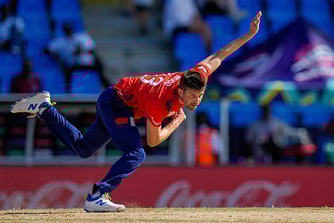 Mark Wood bowls against Oman